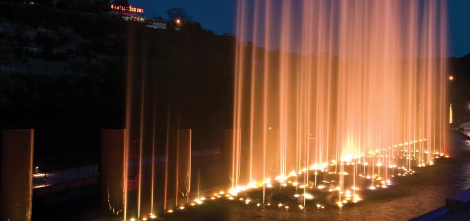 Lights pointing up into the air from a fountain in Branson, Missouri.