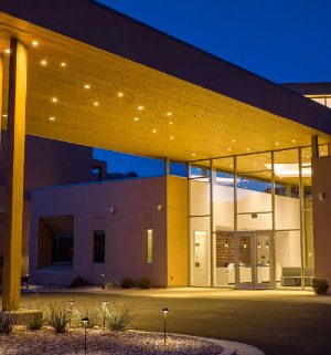 The exterior entrance to WorldMark Moab with bright lights at night.