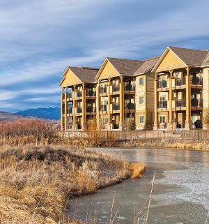 The exterior of WorldMark Rocky Mountain Preserve, a timeshare resort in Granby, Colorado, surrounded by mountains and water.