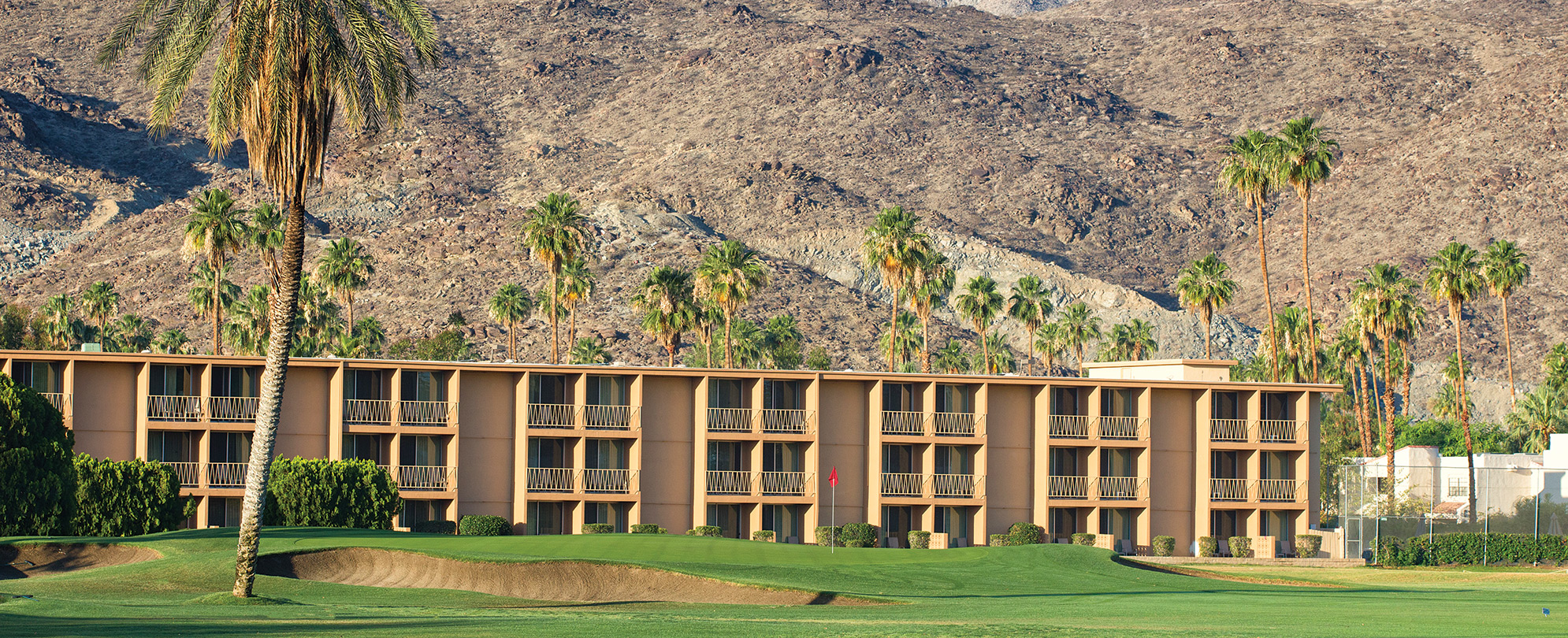 Mountains and a golf course surrounding WorldMark Plaza Resort & Spa, a timeshare resort in Palm Springs, California.