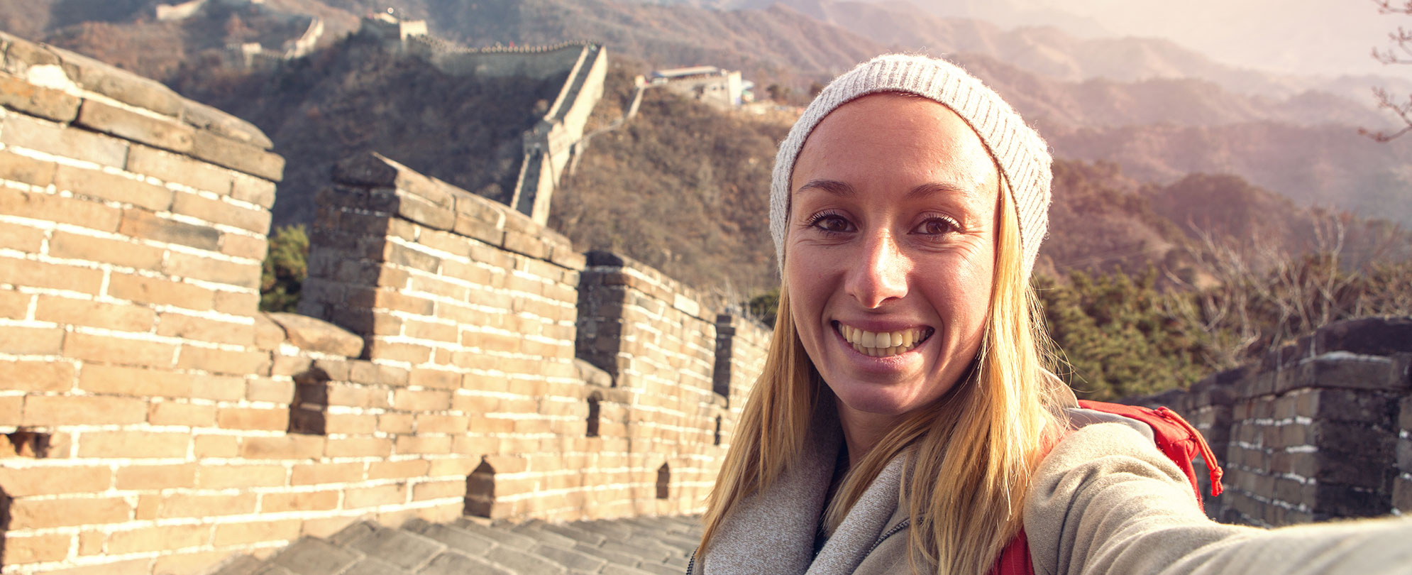 A woman taking a selfie at Great Wall of China.